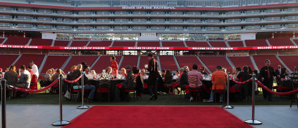 Velvet Rope and Red Carpet leading to a long table of guests at the Levi's Stadium field