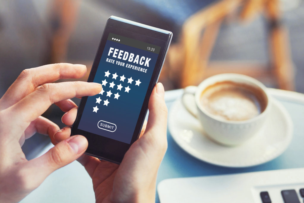 positive feedback, customer satisfaction concept, woman rating service online and writing review on smartphone